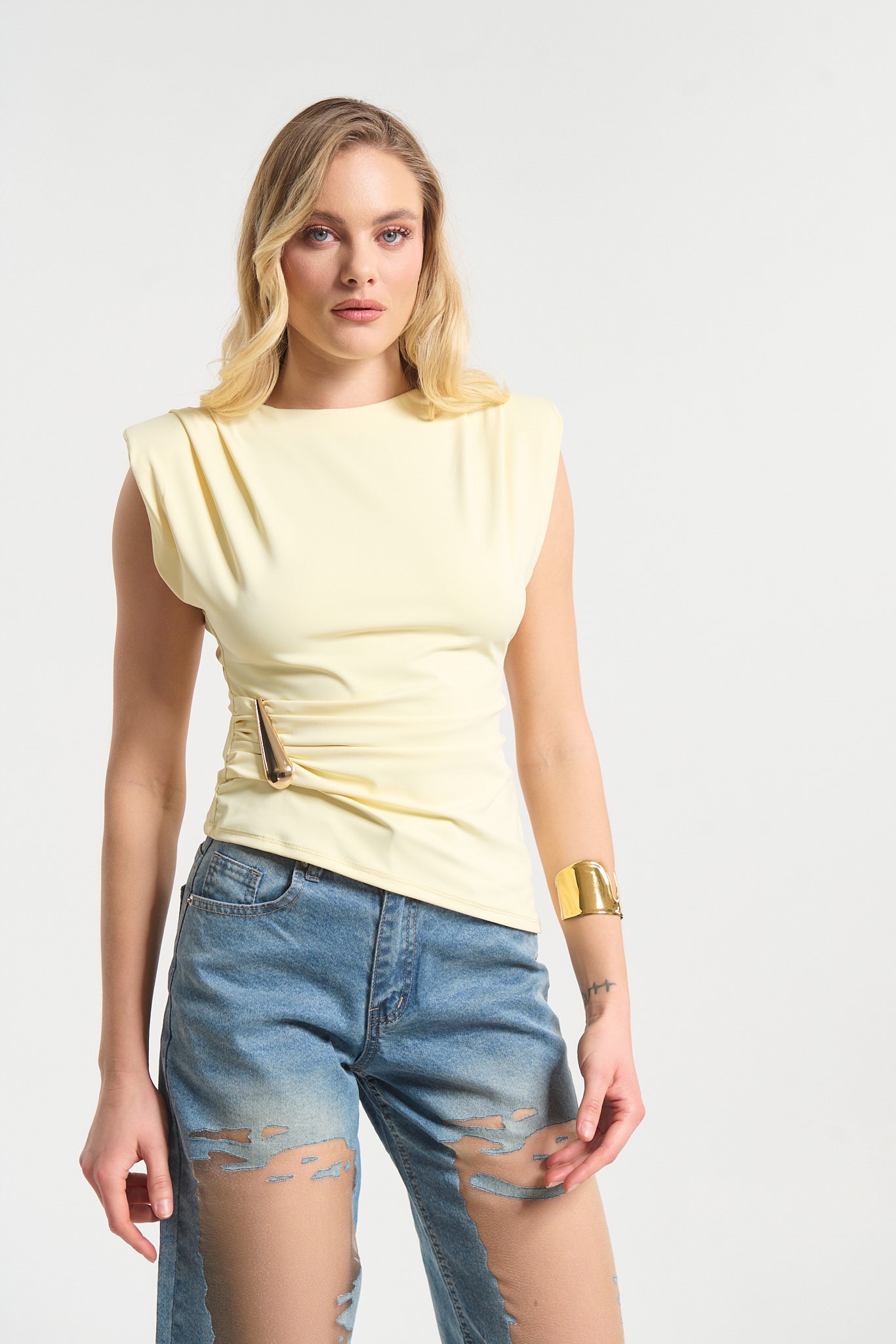 Sleeveless Top Featuring Shoulder Pads and Gold Teardrop Detail