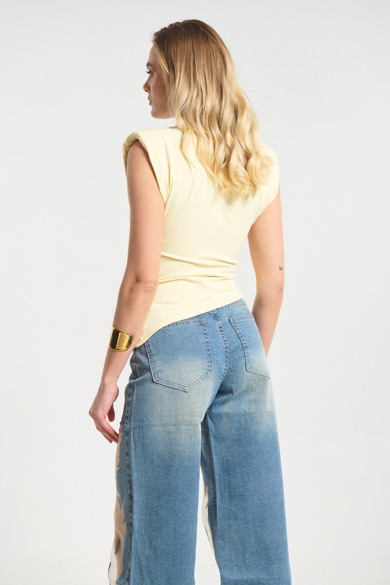 Sleeveless Top Featuring Shoulder Pads and Gold Teardrop Detail