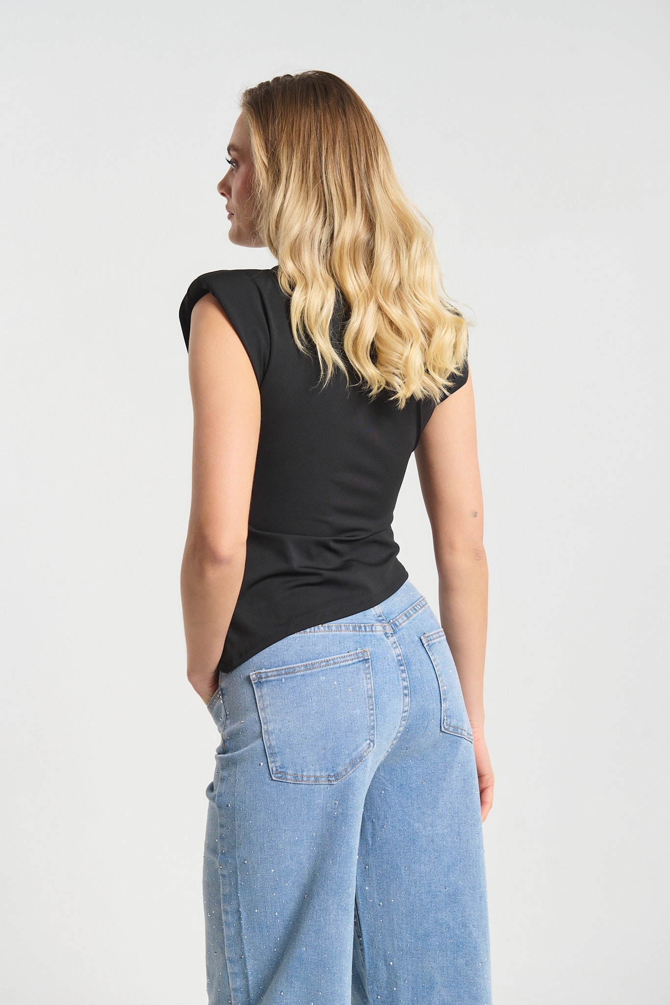 Sleeveless Top Featuring Shoulder Pads and Gold Teardrop Detail